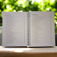 The book open to the table of contents for 100 Group Therapy Activities, showing a list of group therapy activities like "Types of Trauma," "SMART Goal Setting," and "Boundaries."